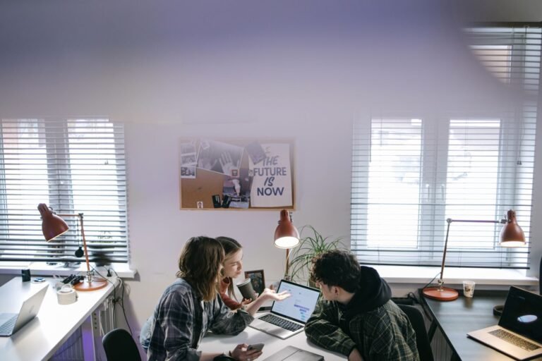 Business team working on laptops in a bright modern office