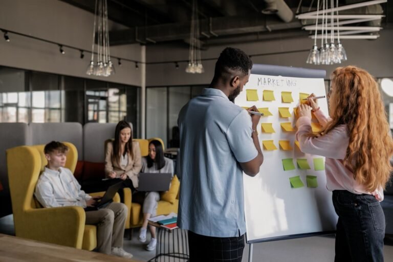 Growing business team planning together at a whiteboard