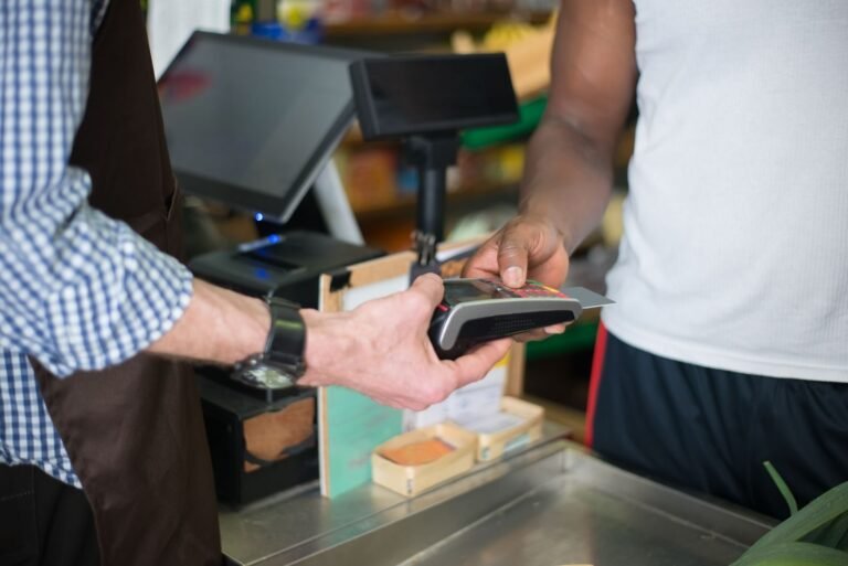 Customer paying by card at a small shop checkout counter