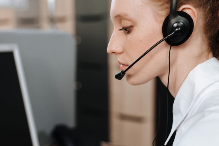 Support specialist wearing a headset while working at a computer